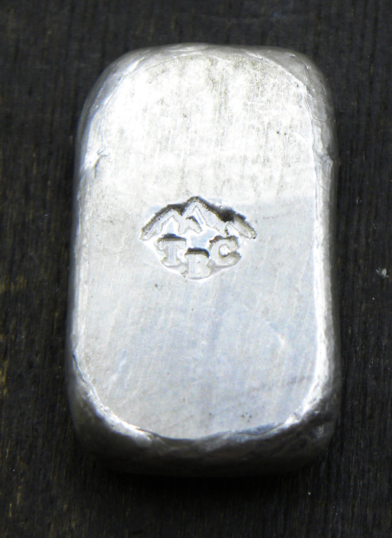 Back view of a 10g fine silver (999FS) bar, featuring a stamped TBC mountain range maker’s mark