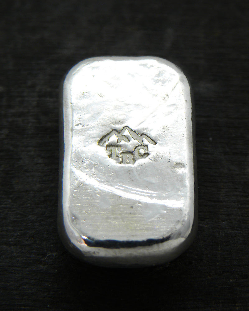 Back view of a 10g fine silver (999FS) bar, featuring a stamped TBC mountain range maker’s mark